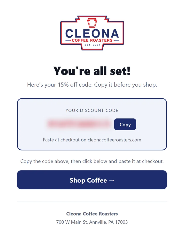 The page shown after signup, with the discount code (blurred) and a link to shop
